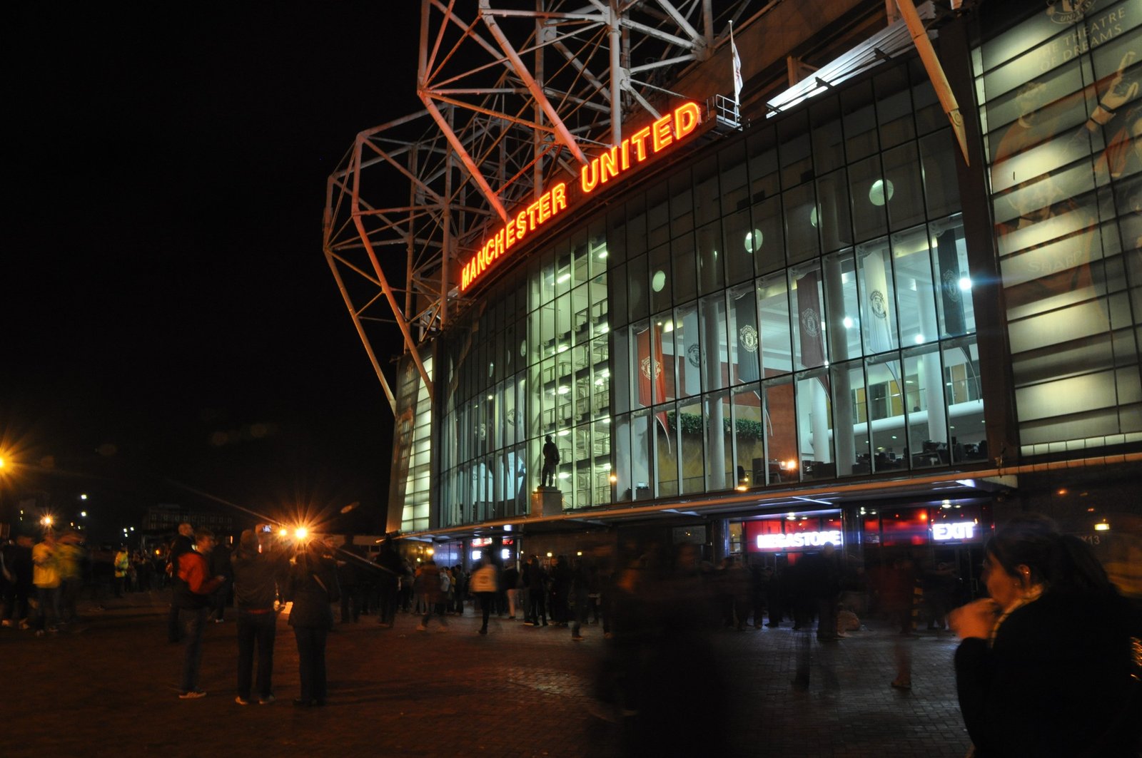Old Trafford at night, where the JJ Gabriel situation at Manchester United is still unresolved